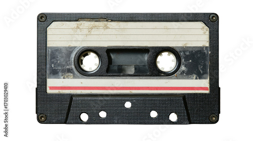 A used audio cassette tape.  Dark gray plastic case, dirty and worn.  Visible tape markings and discoloration.  Two circular holes in the center