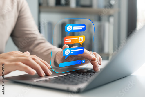 AI chatbot conversation concept on laptop with virtual assistant interface. User typing messages in smart communication system for automated replies, digital support, and customer service solutions.