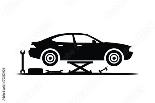 Black car on hydraulic lift with tools vehicle jack