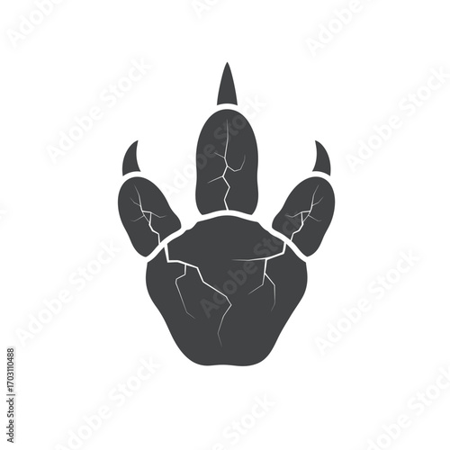 Isolated, dark gray dinosaur footprint with cracks, featuring three toes and sharp claws, on a white background.
