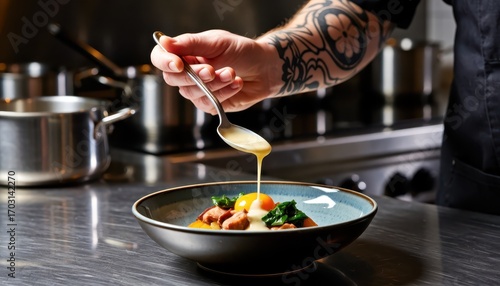 Chef pouring sauce over gourmet dish in modern kitchen culinary art close-up professional environment
