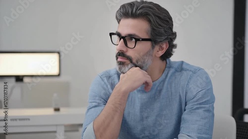 Thoughtful Gaze of Contemplation: A close-up shot of a man with eyeglasses lost in thought, his expression a blend of introspection and contemplation, reflecting deep concentration.