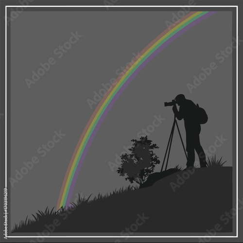 Silhouette of a Photographer Capturing a Rainbow Landscape.