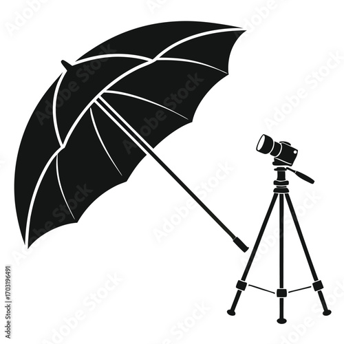 Studio lighting setup with umbrella and camera on tripod.