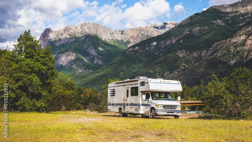 Scenic camping experience with RV near mountains on a sunny day in nature