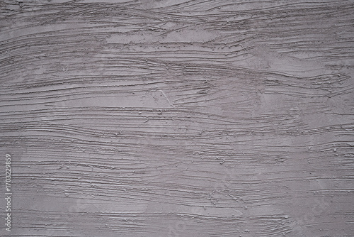 muted gray rough and loft cement plaster wall surface with rugged texture and horizontal grain pattern style image background
