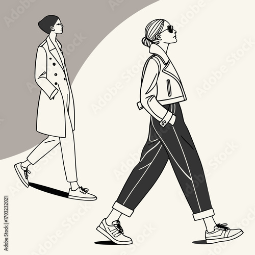 Two stylish women in fashionable outfits walking outdoors