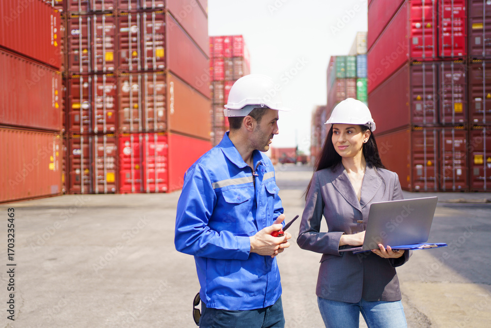 Fototapeta premium Businesswoman talking with container yard officer about import export logistics, global trade, and international shipping management.