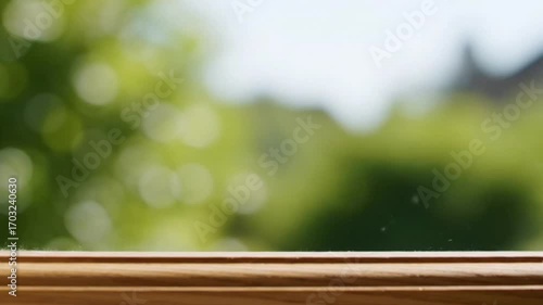 A window frame in a blur view, blurring background of green and natural scene. Capturing the beauty and freshness of outdoors, a scene of simple life.