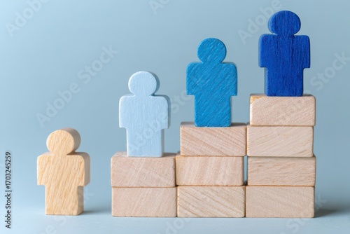 Wooden figures on a tiered block structure, light blue and beige/tan