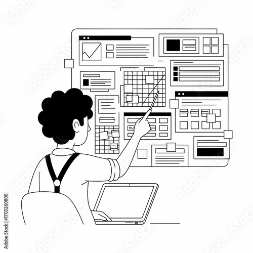 Man pointing at a complex dashboard with laptop in front