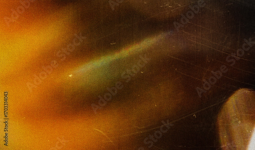 Grainy colorful warm rainbow red light leaks on black background with dust texture. abstract damaged scratched retro film analog effect for using over photos as overlay or screen filter