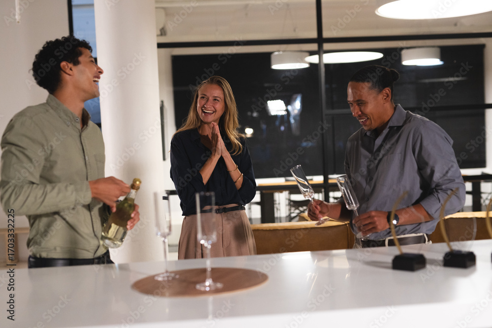 © wavebreak3 - Colleagues celebrating with champagne glasses, laughing and enjoying at office party