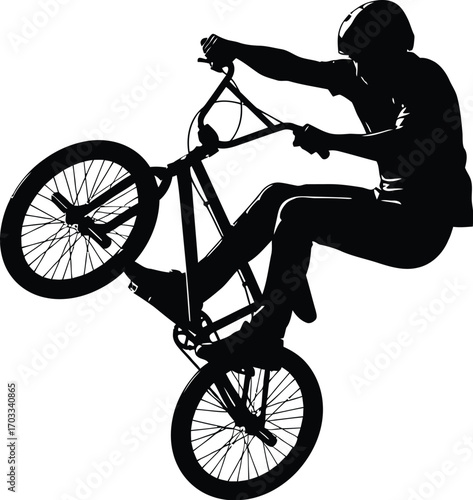 Silhouette of a bmx rider performing a wheelie trick, rider is wearing a helmet and riding a bmx bike
