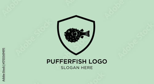 A stylized black pufferfish icon is centered within a shield emblem, with the text "PUFFERFISH LOGO" and "SLOGAN HERE" below on a pale green background.