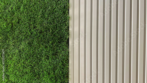 Fotografie Artificial Green Grass Wall And Vertical White Panels, Captured Indoors, Daytime