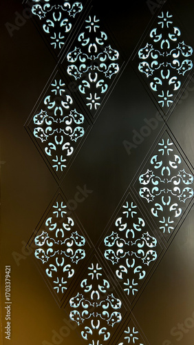 Fotografie Ornamental Wall Panel With Backlit Cut-Out Patterns, Close-Up Of Decorative Geom
