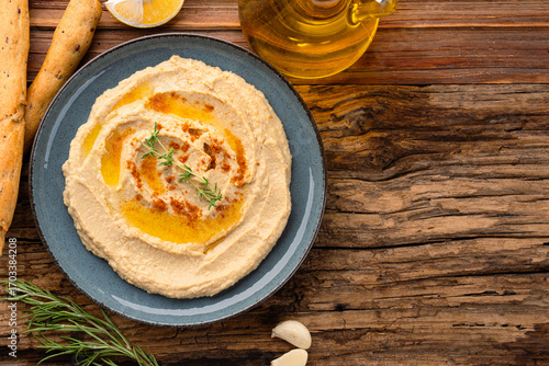 A traditional dish or appetizer hummus or baba ghanoush on wooden background	
