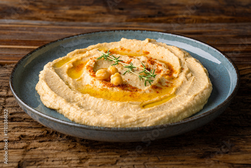A traditional dish or appetizer hummus or baba ghanoush on wooden background	
