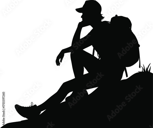 Thoughtful hiker resting on rocky terrain silhouette