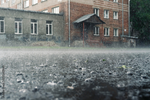 rain in the city, the flow of water along the city street during a downpour, bubbles, drops and splashes during rain