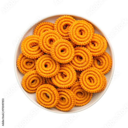 Delicious golden brown chakli snacks arranged artfully on a plate top down view