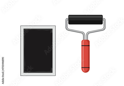 A paint tray with black paint next to a paint roller with a red handle