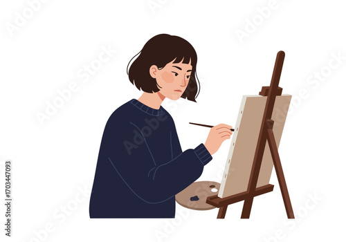 An artist in a blue sweater paints on a canvas propped on an easel