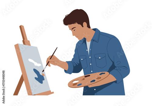 Man in a blue shirt painting on a canvas with a paintbrush and palette