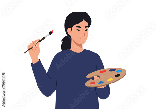 Young adult holds a paint brush and palette