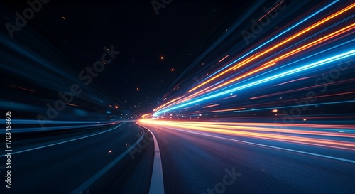 Dynamic neon light trails in blue and orange creating a sense of speed and motion on a dark road. Futuristic abstract background design concept for technology, energy, and fast movement.