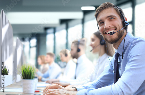 Obraz na płótnie Portrait of call center worker accompanied by his team