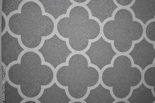Elegant gray and white Moroccan tile pattern creates calming geometric design. sophisticated quatrefoil abstract background for decoration