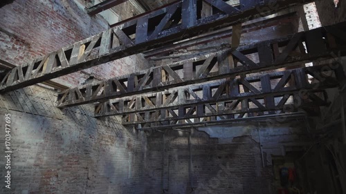 Enormous iron supports reinforce massive brick walls of old building. Strong reinforcements dominate brick structure. Old house renovation