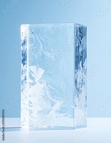 Abstract Close Up of Translucent Ice Cube with Delicate Frost Patterns Against Soft Blue Background