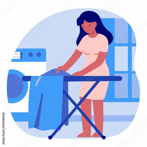 Woman flattening laundry with hands while standing by washing machine  