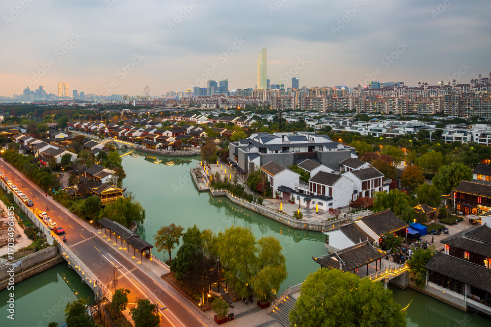 Obraz premium Xietang Old Street water town ancient architecture and modern city skyline in Suzhou, China