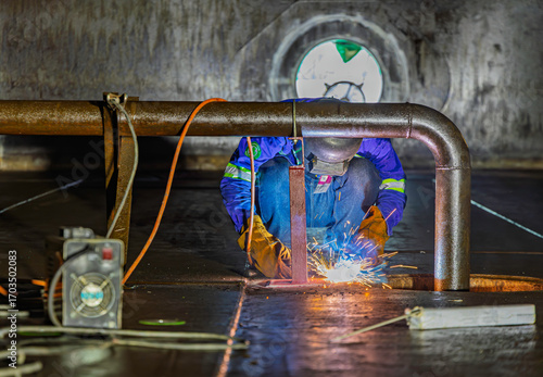Welding male worker metal is part of machinery plate bottom tank sump construction