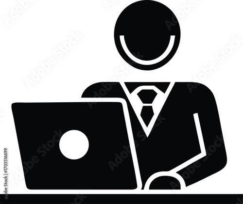 Black business man working at his desk on his laptop diligently in monochrome