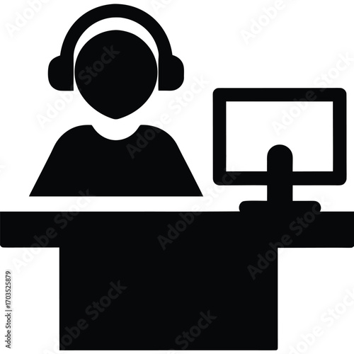 Person wearing headset sits at the black computer desk with a monitor