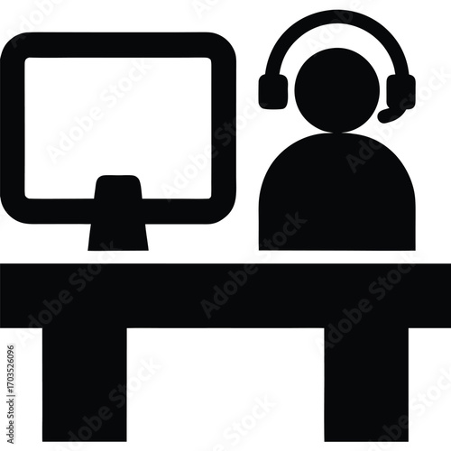 Person with headset sits at computer desk in solid black icon
