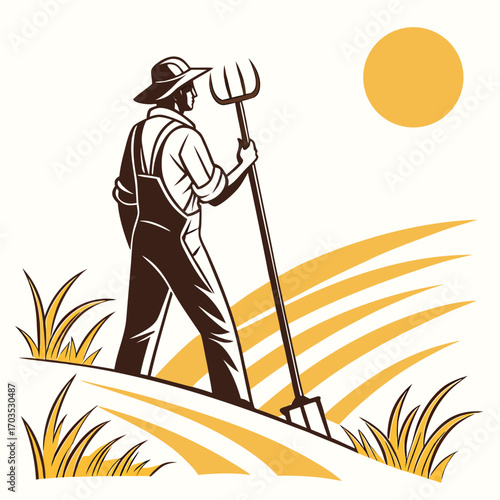 Male farmer with hat stands in a field holding a pitchfork under sun