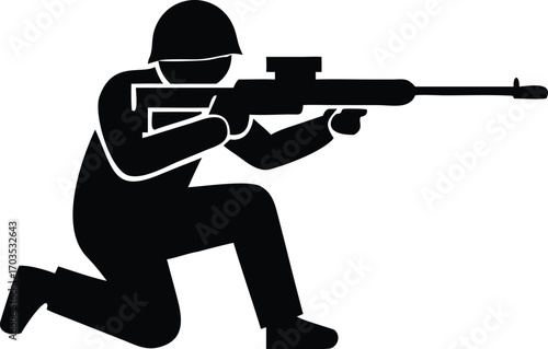Soldier with helmet takes aim while kneeling and carefully holding a rifle