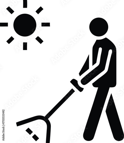 Silhouette man using a rake tool in sun, showcasing landscaping or gardening activity