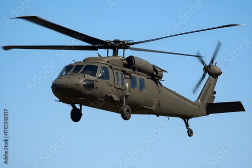 Sikorsky UH-60 Black Hawk Helicopter in Flight
​A Sikorsky UH-60 Black Hawk helicopter, painted in a matte olive drab color, is shown in flight against a clear, deep blue sky.