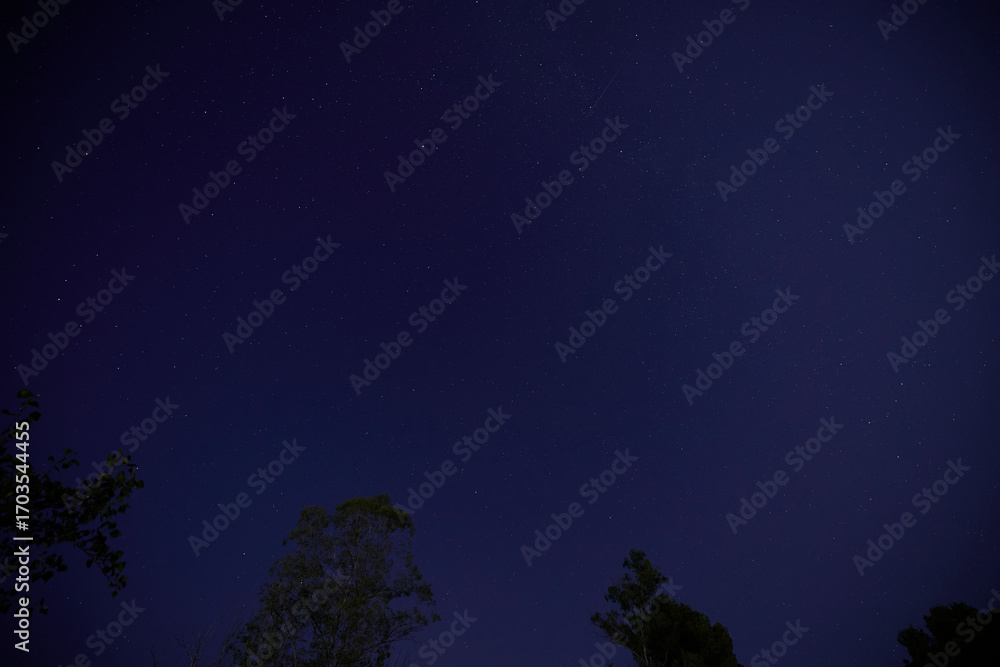 Fototapeta premium Night sky with bright satellite flare