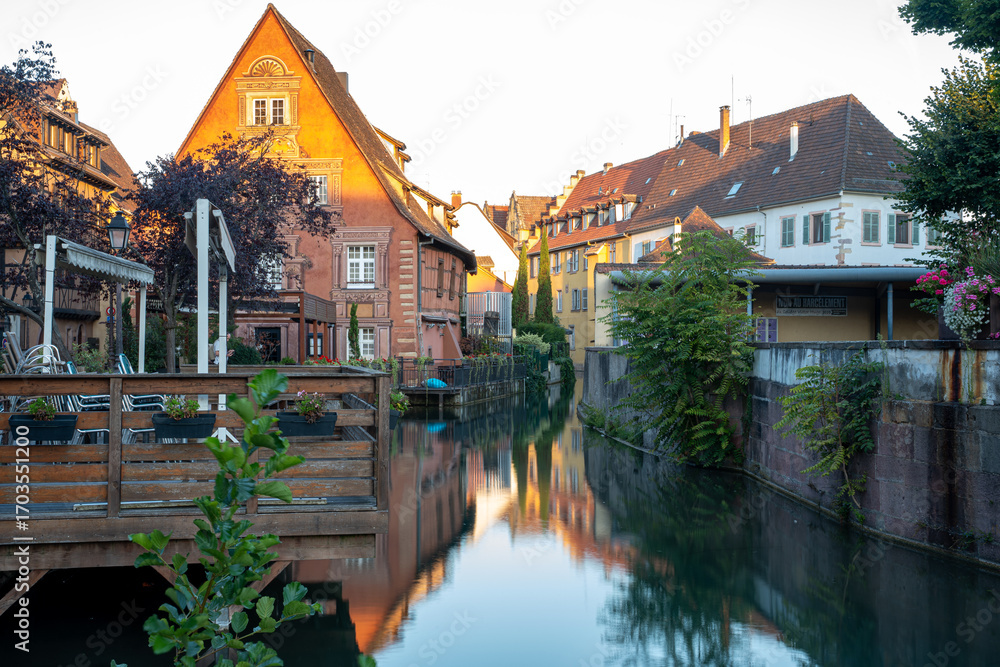 Naklejka premium Sunlit Canals of Colmar at Sunrise in the Old Town