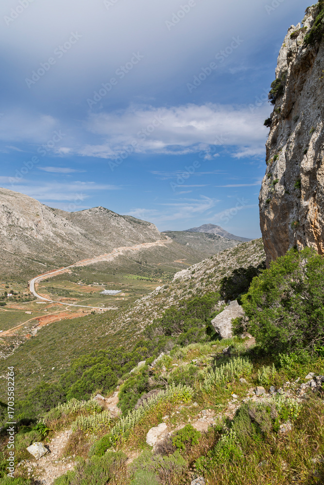 Fototapeta premium Beautiful view of the rocky, lush and mountainous Vathy valley on Kalymnos island in Greece on a sunny day in spring.