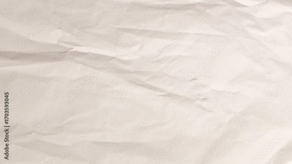 Fototapeta premium A crumpled white paper surface showcases intricate textures under soft, even lighting, perfect for artistic designs or craft work in a creative studio environment