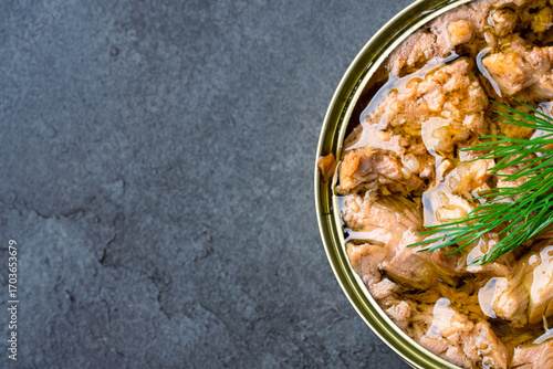 Canned tuna in brine isolated on black  background